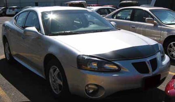 Silver 2004 Pontiac Grand Prix with a black magnetic car bra