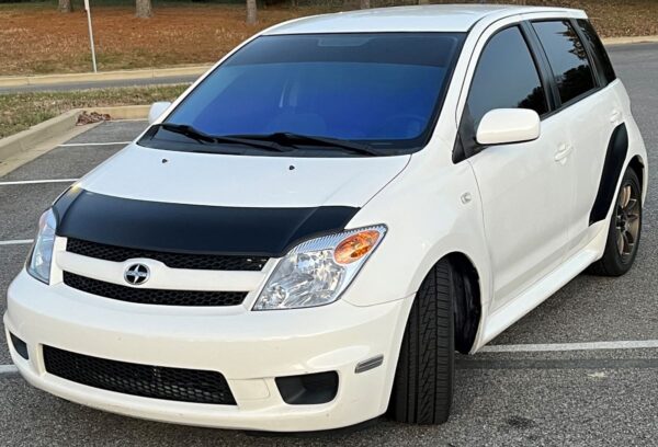 Black bra and garnish on a white 2005 2006 2007 Scion xA Magnetbra and Door Garnish